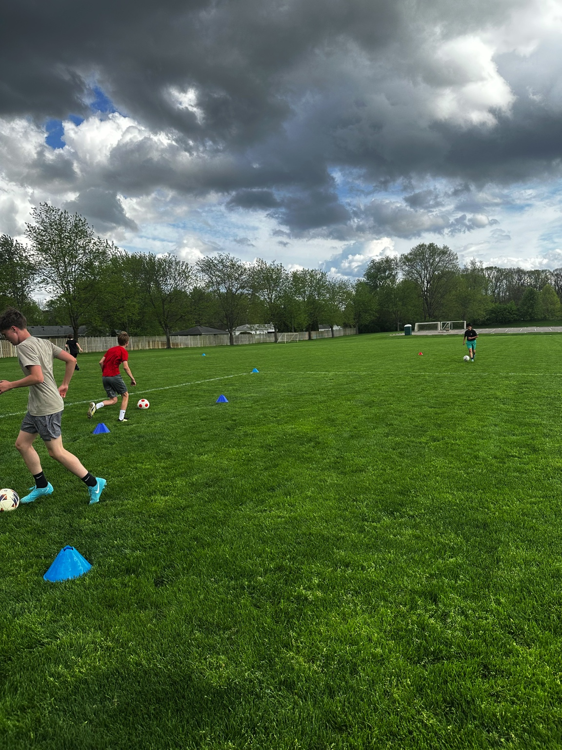 Youth players in group dribbling circuit